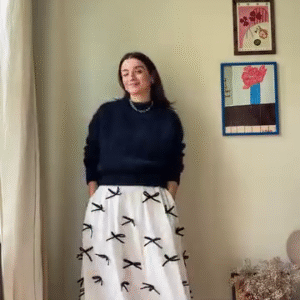 Chic Parisian-Inspired Look: Navy Knit Sweater & White Bow Skirt Ensemble