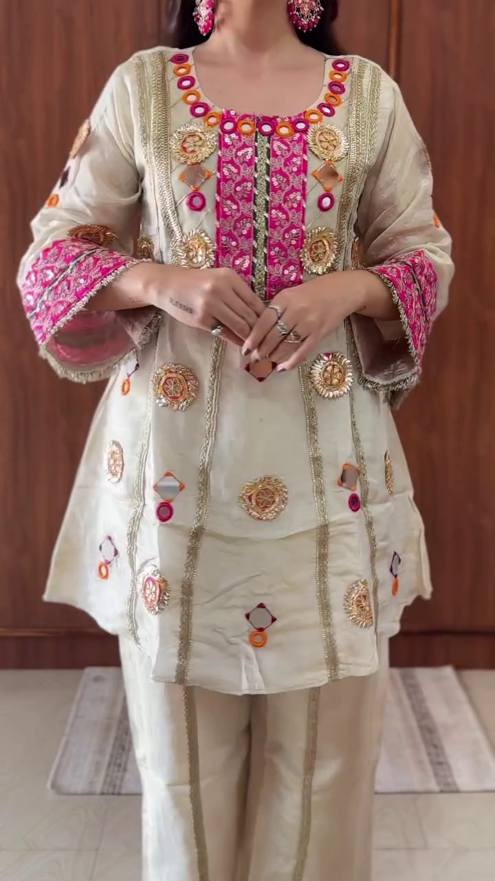 Traditional Ivory Silk Straight Kurta Set with Pink-Gold Mirror Embroidery, Gota Work, and Festive Mirror Appliqué Accents Paired with Coordinated Palazzo Pants